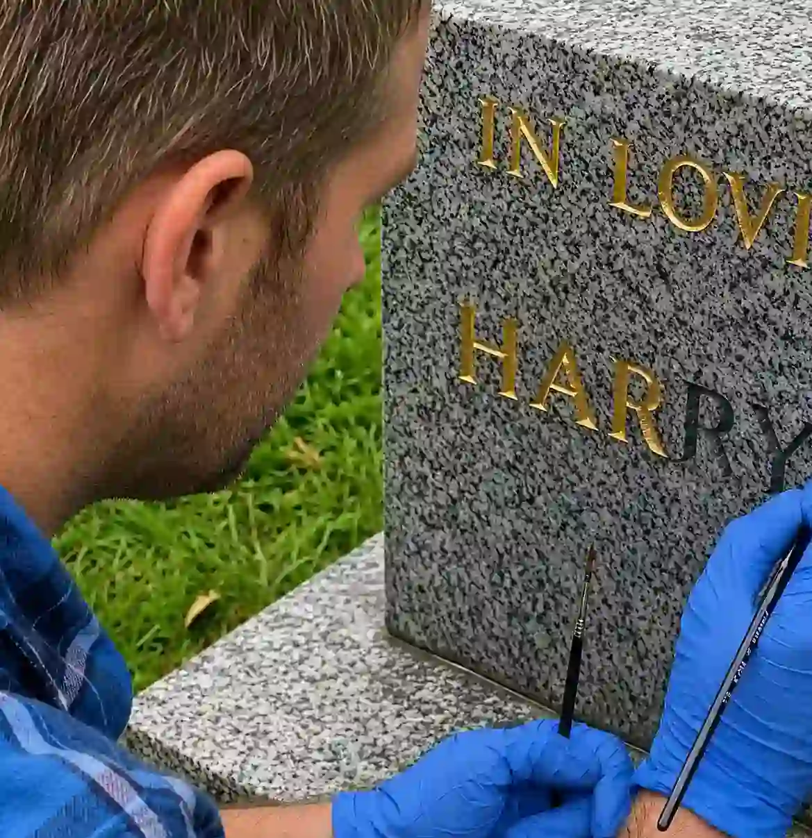 Brush repainting incised letters on a headstone