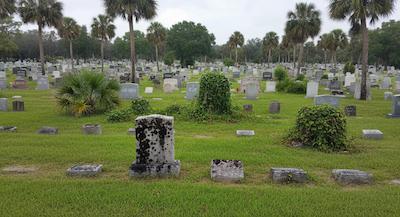 Professional headstone cleaning service at a cemetery in Florida