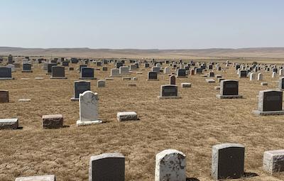 Professional headstone cleaning service at a cemetery in Texas