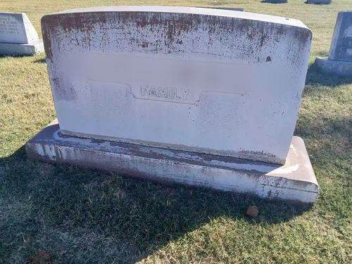 Upright granite headstone before Tending's professional cleaning services