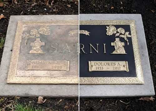 Hands re-leveling a granite monument with masonry tools