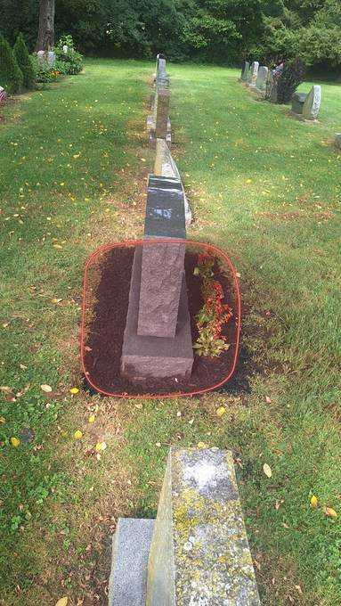 Grave-site cleanup covering the ground right around the stone