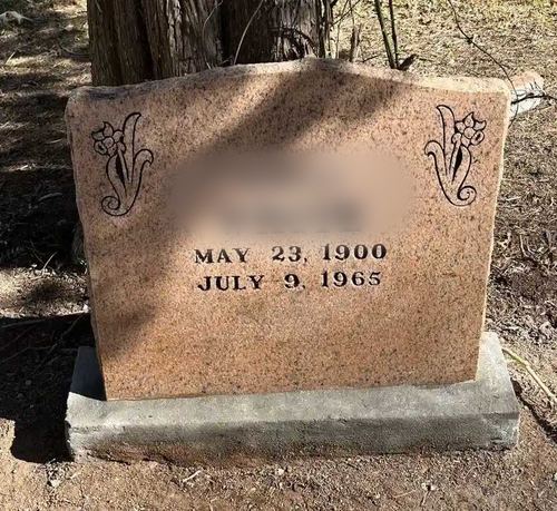 Pink-granite slant headstone after Tending's lettering repair and deep cleaning