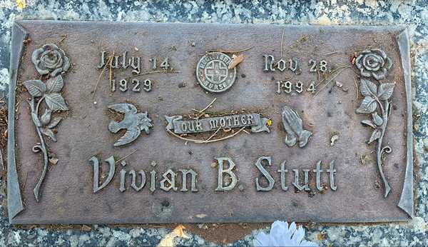 An old, heavily oxidized bronze cemetery plaque before restoration