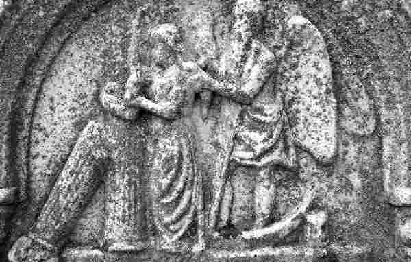A gravestone carving depicting a draped urn, a traditional symbol of mourning