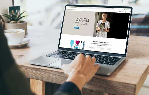 A person searching online genealogy databases to find family cemetery records