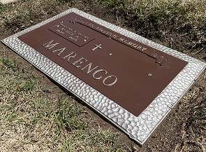 The same bronze grave marker after professional restoration and protective clear coat sealing