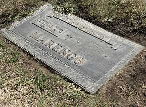 A weathered and heavily oxidized bronze memorial plaque before cleaning