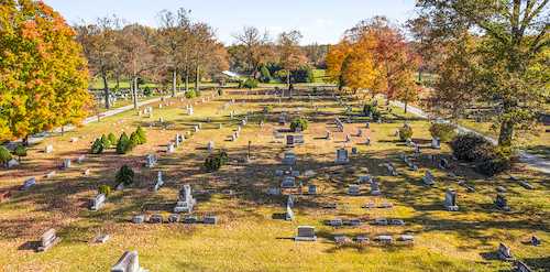Aerial view of an old cemetery in autumn, a key location for gravestone genealogy research and family history tracing
