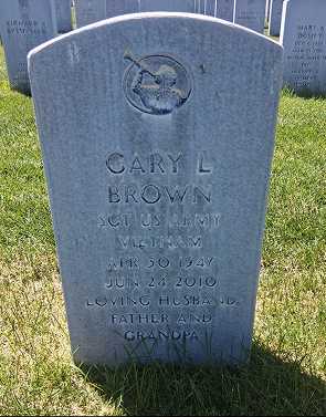 A cemetery monument with heavily faded and unreadable carved lettering